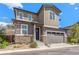 Inviting two-story home featuring a stone facade, neutral siding, and attached two-car garage at 11235 S Neu Towne Cir, Parker, CO 80134
