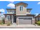 Charming two-story home with neutral siding, stone accents, and a two-car garage on a sunny day at 11235 S Neu Towne Cir, Parker, CO 80134