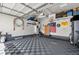 Spacious garage featuring a checkered floor, basketball hoop, and storage at 11235 S Neu Towne Cir, Parker, CO 80134