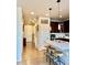 Open-concept kitchen featuring a center island with stool seating and modern lighting at 11235 S Neu Towne Cir, Parker, CO 80134