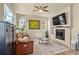 Cozy living room with a fireplace, comfortable seating, and a ceiling fan at 11235 S Neu Towne Cir, Parker, CO 80134