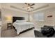 Comfortable main bedroom with a tray ceiling, a ceiling fan, and a large window at 11235 S Neu Towne Cir, Parker, CO 80134