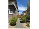 Landscaped side yard with gravel path, lush green shrubs, and a wood fence at 11235 S Neu Towne Cir, Parker, CO 80134