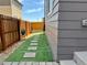 Landscaped side yard with artificial turf and a walkway leading to the backyard at 11235 S Neu Towne Cir, Parker, CO 80134