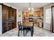 Eat-in kitchen boasts warm cabinets, stainless appliances, and a rustic sliding barn door at 7245 Prairie Cir, Longmont, CO 80504