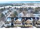 Aerial view of a townhouse complex with snow covered roofs surrounded by trees at 4771 White Rock Cir # C, Boulder, CO 80301