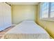 Minimalist bedroom featuring wood floors, a large window, neutral paint, and a sliding barn door at 4771 White Rock Cir # C, Boulder, CO 80301