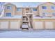 Townhouse exterior featuring attached garages and outdoor stairway at 4771 White Rock Cir # C, Boulder, CO 80301