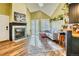 Cozy living room featuring a fireplace, wood floors and a large area rug that is well-lit by natural light at 4771 White Rock Cir # C, Boulder, CO 80301