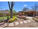 Beautiful backyard with a stone patio, firepit, pergola, and mature landscaping at 2064 Ironton St, Aurora, CO 80010