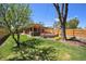 Spacious backyard featuring a patio with pergola, hot tub, firepit, and lush green grass at 2064 Ironton St, Aurora, CO 80010