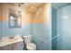 Bathroom showcasing tiled walls, toilet, and shower area at 2064 Ironton St, Aurora, CO 80010