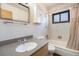 Well-lit bathroom with a shower-tub combo, vanity, and a mirrored cabinet at 2064 Ironton St, Aurora, CO 80010
