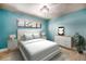 Comfortable bedroom with hardwood floors, a dresser, and neutral colored walls at 2064 Ironton St, Aurora, CO 80010