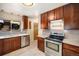 Well-appointed kitchen with stainless steel appliances, granite countertops, and dark wood cabinets at 2064 Ironton St, Aurora, CO 80010