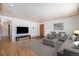 Spacious living room with hardwood floors, neutral furniture, and natural light at 2064 Ironton St, Aurora, CO 80010