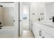 Stylish bathroom boasts a modern vanity with black fixtures and tub shower at 1733 Fox Trotter Pt, Castle Rock, CO 80104