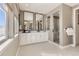 Contemporary bathroom with double vanity, walk-in shower, and ample natural light, creating a spa-like atmosphere at 1733 Fox Trotter Pt, Castle Rock, CO 80104