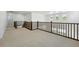 Upstairs hallway with wood railing and a view to the outside at 1733 Fox Trotter Pt, Castle Rock, CO 80104