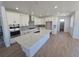 Bright kitchen with a large center island, white cabinets, and stainless steel appliances at 1733 Fox Trotter Pt, Castle Rock, CO 80104