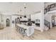 Modern white kitchen with a large center island, stainless steel appliances, and plenty of counter space at 1733 Fox Trotter Pt, Castle Rock, CO 80104