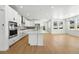 Open concept kitchen features a large kitchen island, stainless appliances, and hardwood floors at 1733 Fox Trotter Pt, Castle Rock, CO 80104