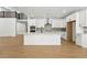 Modern kitchen with white cabinets, stainless steel appliances, and a large center island at 1733 Fox Trotter Pt, Castle Rock, CO 80104