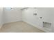 Convenient laundry room includes tile flooring and utility connections at 1733 Fox Trotter Pt, Castle Rock, CO 80104