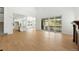Expansive living area featuring hardwood floors, a walk-out patio, and views of the kitchen at 1733 Fox Trotter Pt, Castle Rock, CO 80104