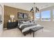 Beautiful main bedroom with wood paneled accent wall, stylish lighting, and comfortable furnishings at 1733 Fox Trotter Pt, Castle Rock, CO 80104
