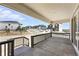 Inviting covered porch with wood railing offers neighborhood views at 1733 Fox Trotter Pt, Castle Rock, CO 80104