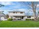 Spacious backyard with lush green lawn and covered patio attached to the house at 3930 S Spruce St, Denver, CO 80237