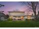 Back of home featuring large lawn, mature trees, and an covered patio at 3930 S Spruce St, Denver, CO 80237