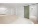 Finished basement featuring neutral carpet, white walls, and a sliding barn door at 3930 S Spruce St, Denver, CO 80237