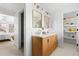 Bathroom featuring a double vanity with a marble countertop and wood drawers with views into the bedroom at 3930 S Spruce St, Denver, CO 80237