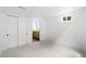 Carpeted bedroom with white walls, closet, and a view to the en suite bathroom at 3930 S Spruce St, Denver, CO 80237