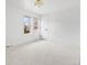 Bright, minimalist bedroom with a neutral carpet and a large window, perfect for creating a serene atmosphere at 3930 S Spruce St, Denver, CO 80237