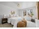 Bright bedroom featuring a cozy bed with decorative pillows and plenty of natural light at 3930 S Spruce St, Denver, CO 80237