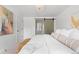 Bedroom with a sliding barn door to the bathroom, comfortable bed, and modern decor at 3930 S Spruce St, Denver, CO 80237