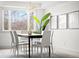 Bright dining area features an adjacent view of the living area with a modern table, chairs, and artwork at 3930 S Spruce St, Denver, CO 80237