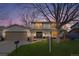 Charming two-story home featuring a well-manicured lawn, double front doors, and attached two-car garage at 3930 S Spruce St, Denver, CO 80237