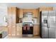 Bright kitchen with wooden cabinets and stainless-steel appliances at 3930 S Spruce St, Denver, CO 80237