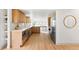 Bright kitchen features natural wood cabinets, modern appliances, and easy access to the dining area at 3930 S Spruce St, Denver, CO 80237