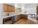 Well-lit kitchen featuring wooden cabinets, stainless steel appliances, and an open layout at 3930 S Spruce St, Denver, CO 80237