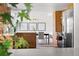 Well-lit kitchen with stainless steel appliances and wooden cabinets, with a view into the dining area at 3930 S Spruce St, Denver, CO 80237