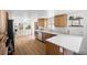 Bright and spacious kitchen featuring hardwood floors, white countertops and wooden cabinets at 3930 S Spruce St, Denver, CO 80237