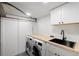 A convenient laundry room offers a sink and modern appliances at 3930 S Spruce St, Denver, CO 80237