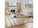 Bright living room with fireplace, modern furniture, and large windows that allow natural light at 3930 S Spruce St, Denver, CO 80237