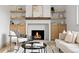 Bright living room with fireplace, modern furniture and decor, and built-in shelving at 3930 S Spruce St, Denver, CO 80237