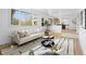 Bright living room with white sofa, modern decor, and a view into the kitchen at 3930 S Spruce St, Denver, CO 80237